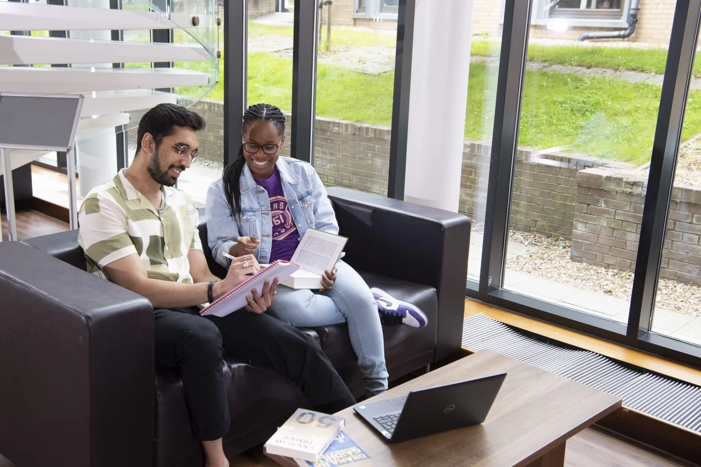 Keshav discussing a document with a fellow student at university